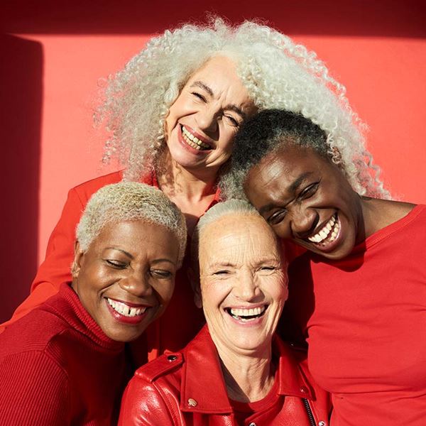Four women smiling together